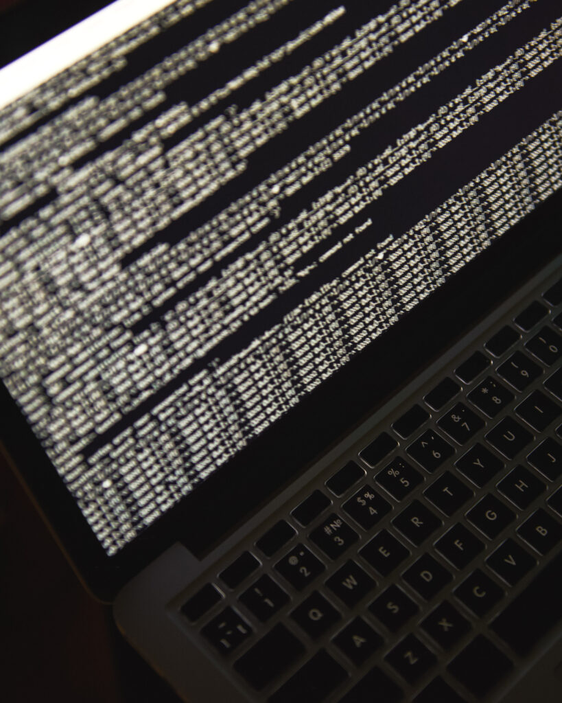 Gros plan sur l’écran de l’ordinateur portable avec un code binaire. Cyberattaque.